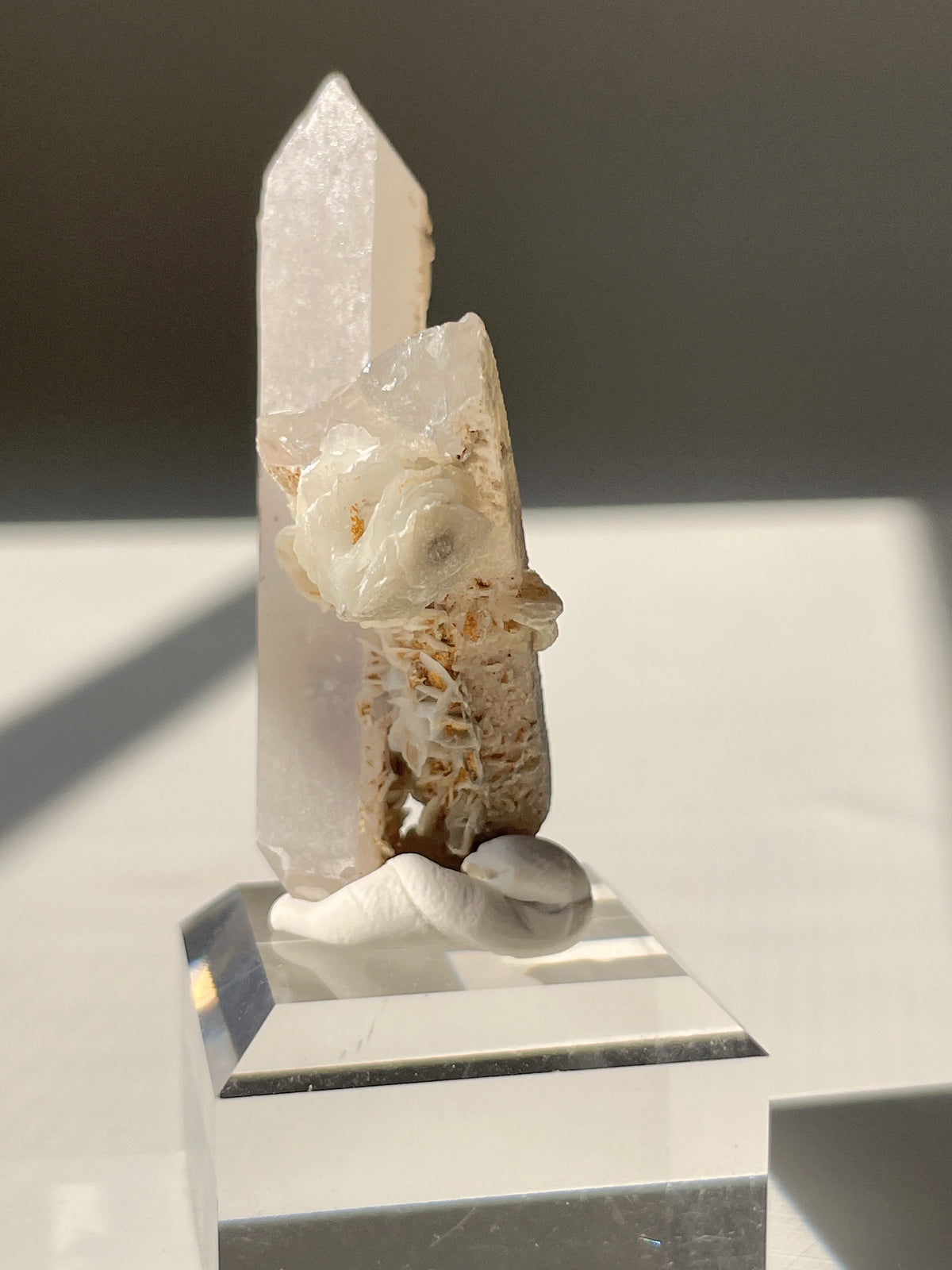 Beautiful flower calcite crystal specimen on quartz, showcasing delicate floral patterns and a polished base.