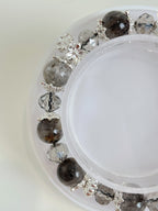 Beautiful quartz bracelet featuring 9.5mm crystal beads and decorative silver accents, elegantly displayed.