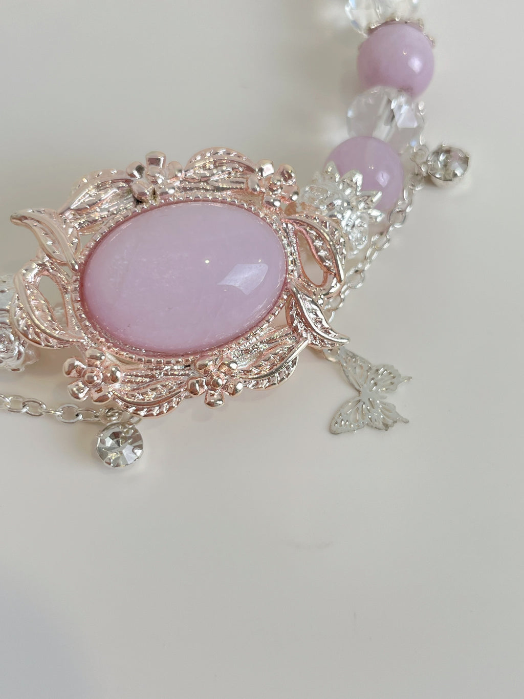 Elegant Kunzite bracelet featuring a pink oval stone and delicate floral accents, accented with sparkling crystals.