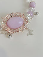 Elegant Kunzite bracelet featuring a pink oval stone and delicate floral accents, accented with sparkling crystals.