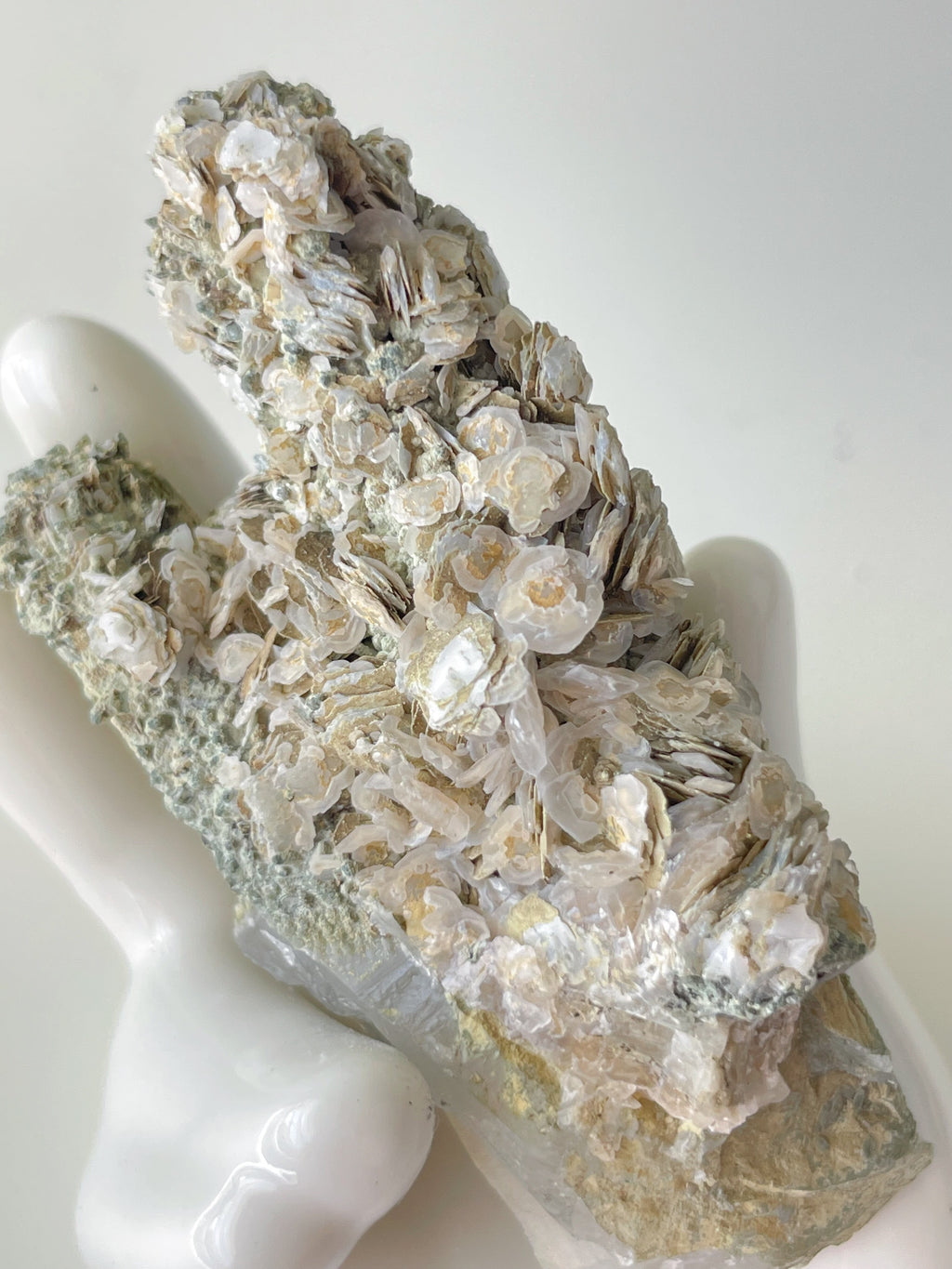 Beautiful Rosette Petal Calcite specimen with intricate textures, resting on a smooth surface.