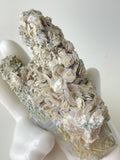 Beautiful Rosette Petal Calcite specimen with intricate textures, resting on a smooth surface.