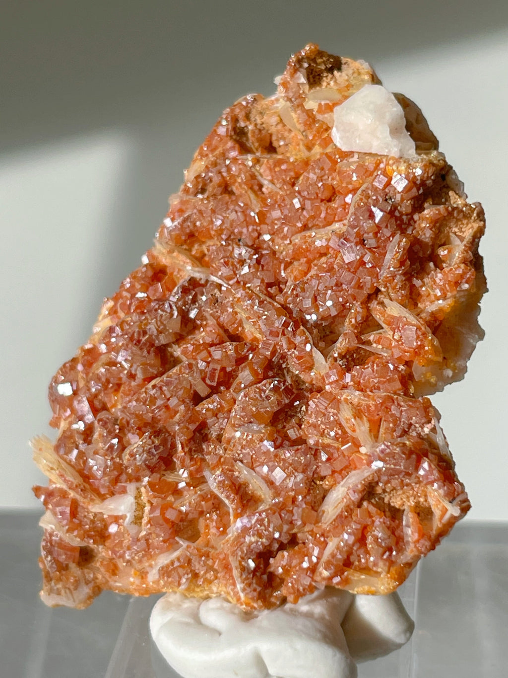 Moroccan vanadinite on barite, showcasing vibrant orange-red crystals with sparkling facets.
