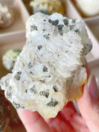 Beautiful crystal specimen featuring pyrite on pagoda calcite, showcasing intricate textures and natural colors.