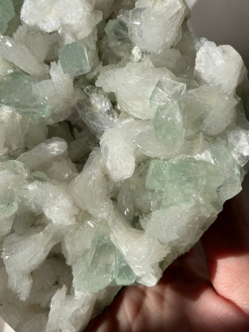 Beautiful crystal specimen featuring green apophyllite and stilbite, showcasing intricate textures and colors.