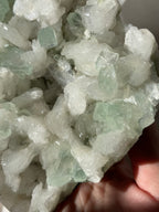 Beautiful crystal specimen featuring green apophyllite and stilbite, showcasing intricate textures and colors.