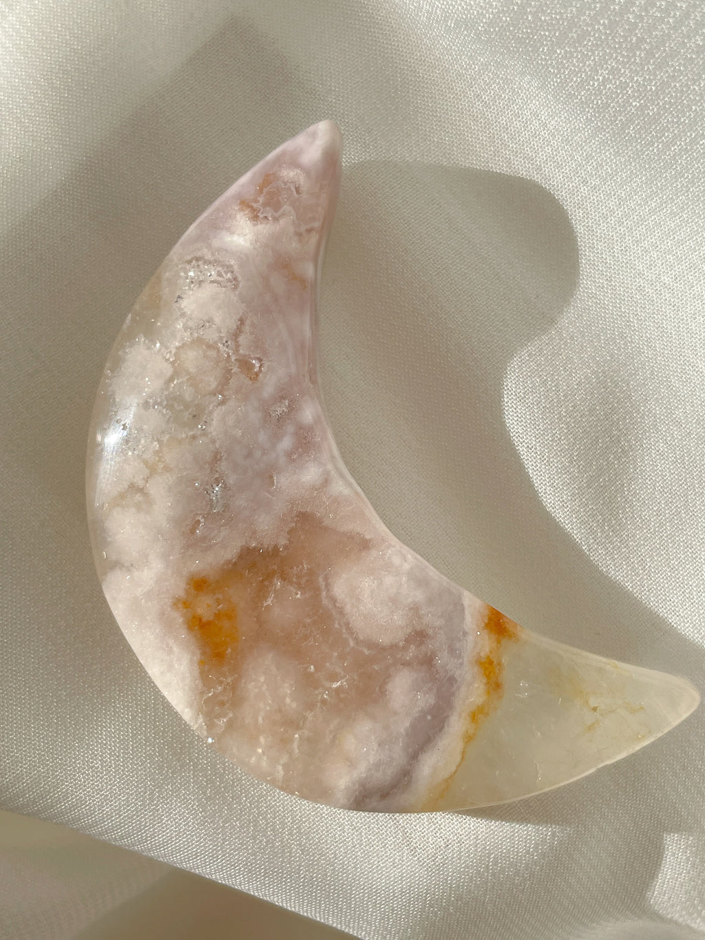 Beautiful flower agate moon with soft pink and cream hues, showcasing natural patterns and a polished finish.