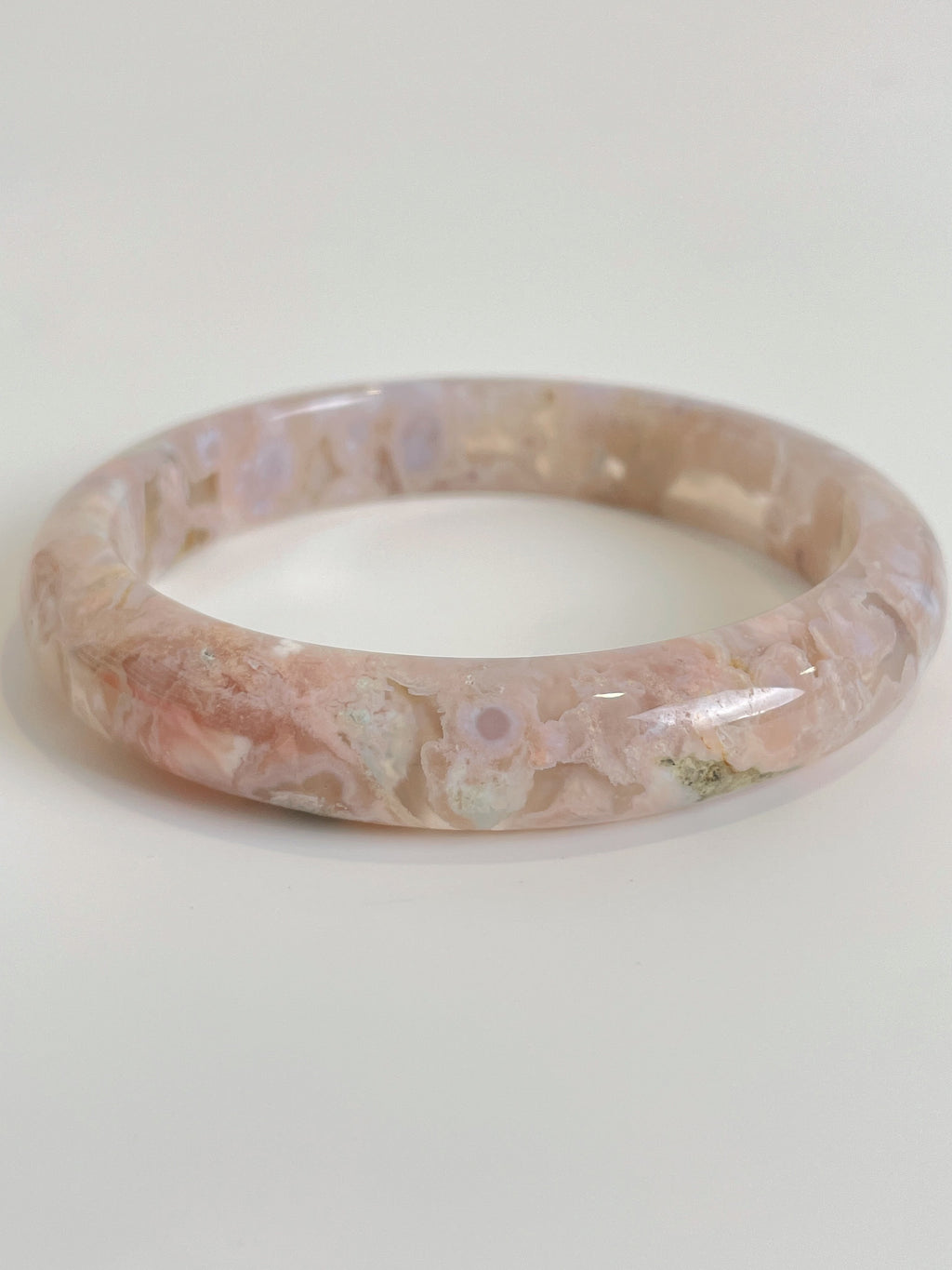 Beautiful flower agate bangle showcasing soft pink hues and unique natural patterns, perfect for stylish wear.