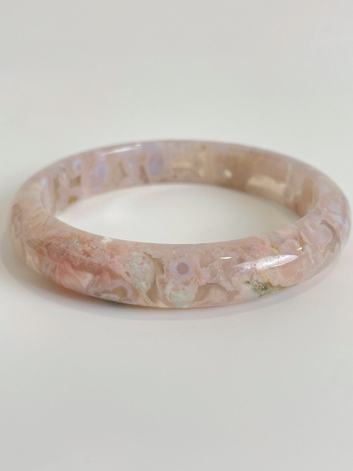 Beautiful flower agate bangle showcasing soft pink hues and unique natural patterns, perfect for stylish wear.