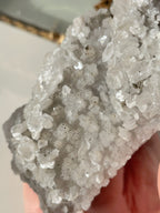 Beautiful crystal specimen featuring sparkling pyrite and calcite on quartz, showcasing natural textures and colors.