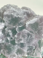 Beautiful crystal specimen of 1KG sugar fluorite with a mix of green and purple hues, showcasing its natural texture.