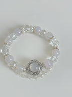 Elegant white agate bracelet featuring 10mm beads, adorned with sparkling crystal accents and a decorative centerpiece.