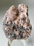 Beautiful pink calcite specimen with quartz and arsenopyrite, showcasing intricate textures and colors.