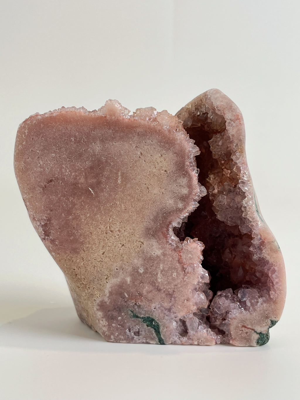 Botryoidal pink amethyst freeform specimen with a smooth exterior and sparkling interior, showcasing natural beauty.