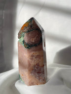 Beautiful pink amethyst tower with scenic moss agate and flower agate accents, glistening in soft light.