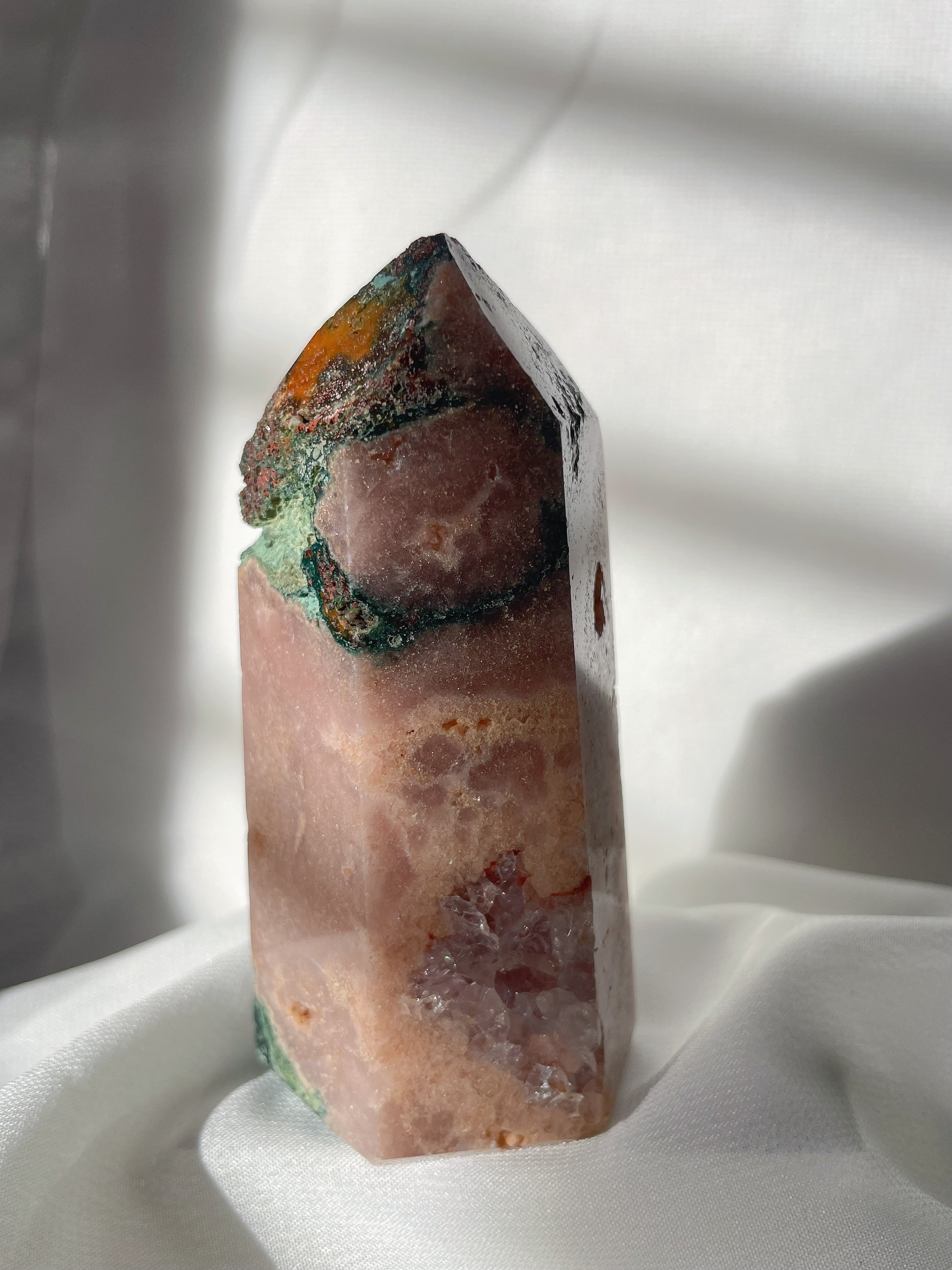 Beautiful pink amethyst tower with scenic moss agate and flower agate accents, glistening in soft light.