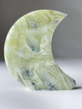Green Maligano Jasper moon-shaped crystal specimen with unique patterns and textures, beautifully polished.