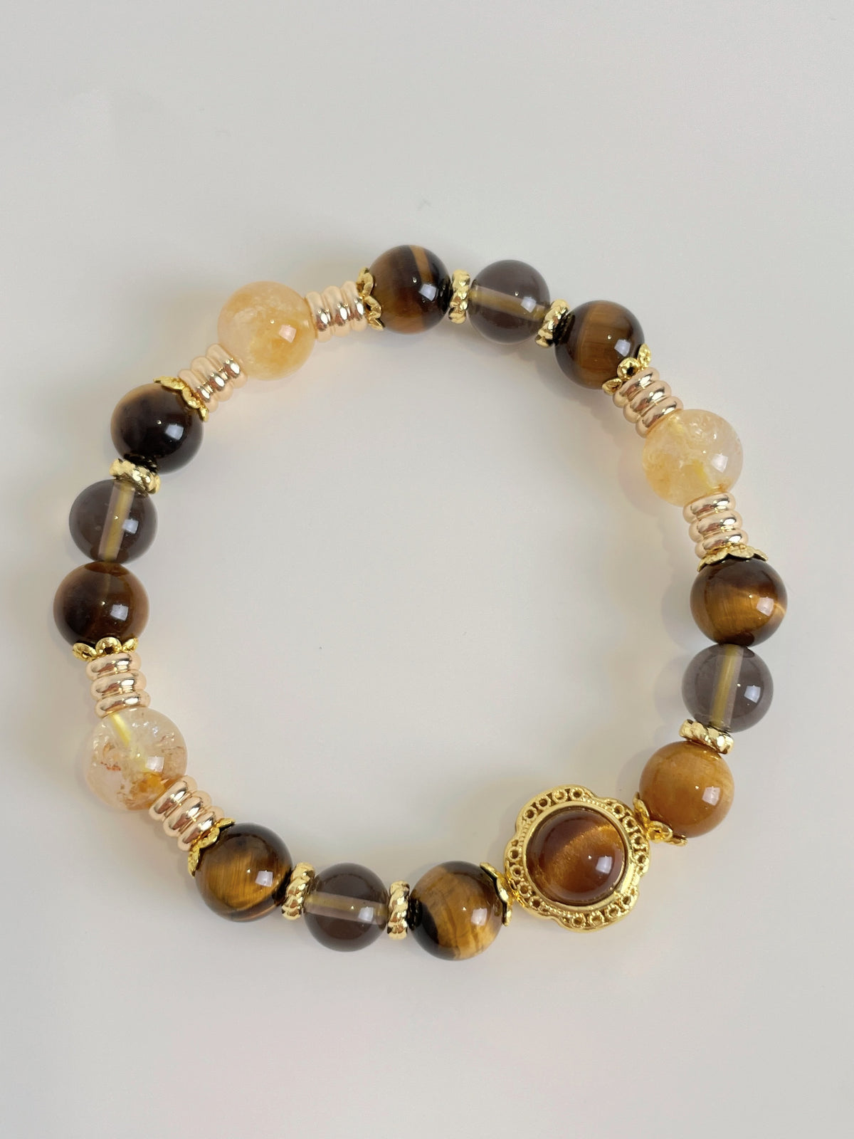 Beautiful bracelet featuring 8.5mm Tiger's Eye and Golden Healer beads, accented with gold-toned spacers.