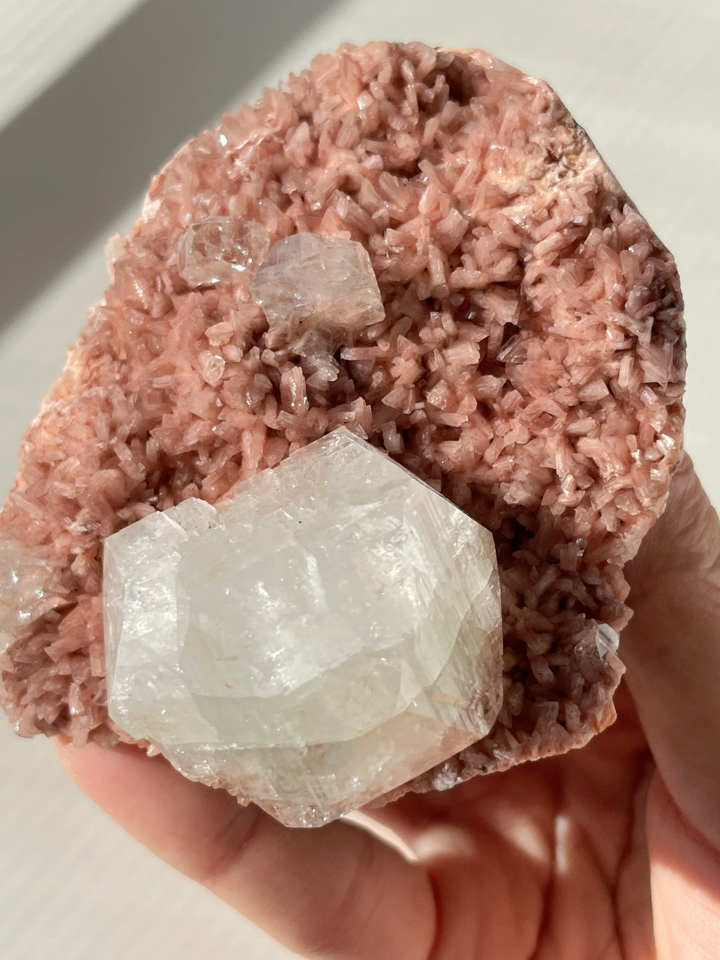 Beautiful pink Heulandite specimen with clear Apophyllite crystals, showcasing natural mineral formations.