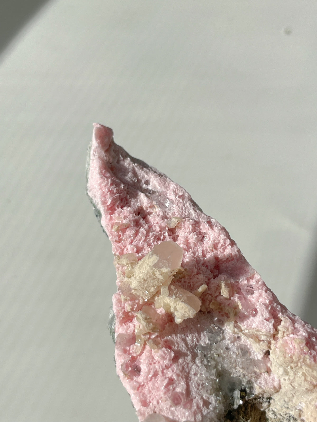 Beautiful rhodochrosite cluster with pink hues and crystal formations, showcasing natural mineral beauty.