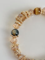 Beautiful blue tiger's eye bracelet featuring 8.5mm beads with golden accents and sparkling crystal elements.