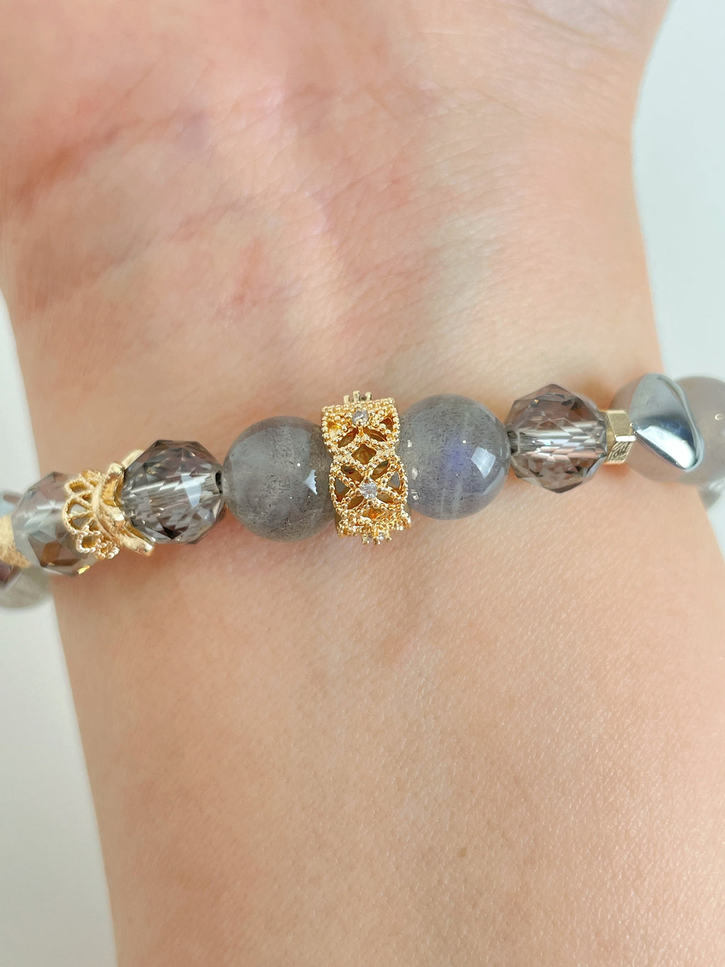 Labradorite bracelet featuring 9mm beads with gold accents, elegantly displayed on a wrist.