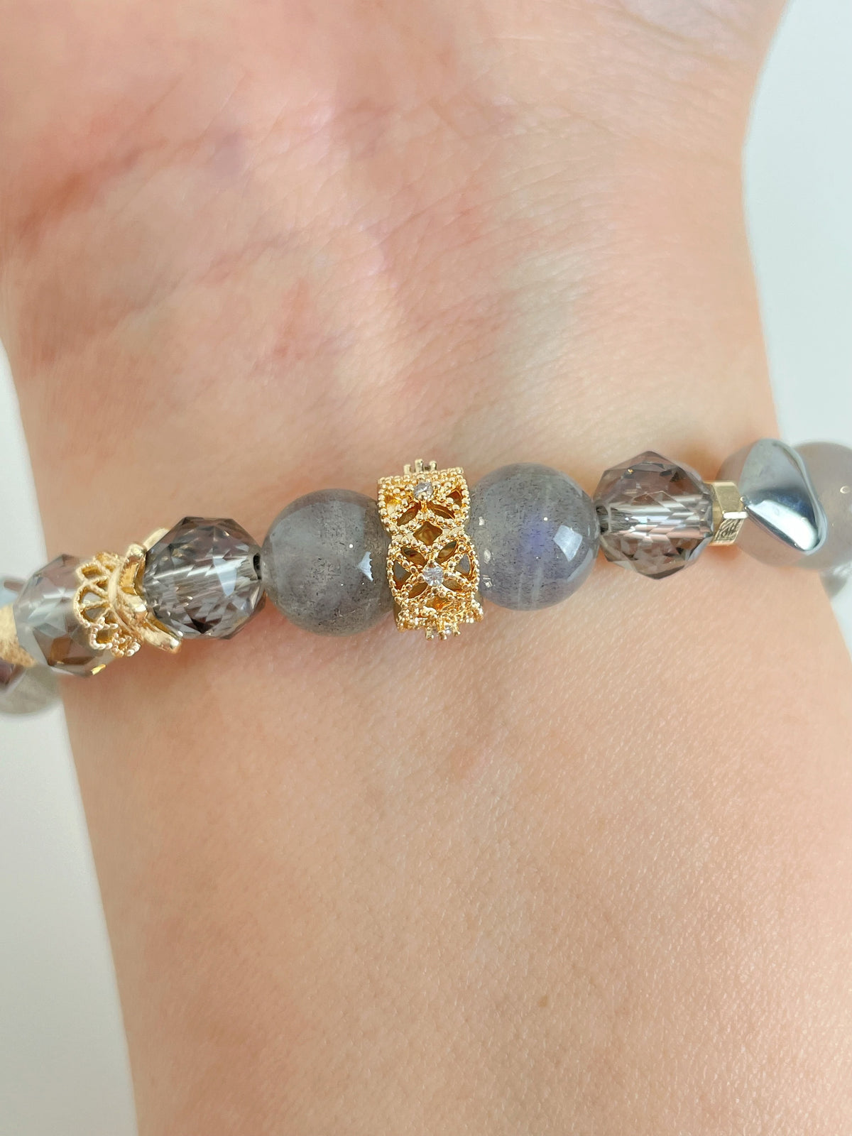 Labradorite bracelet featuring 9mm beads with gold accents, elegantly displayed on a wrist.