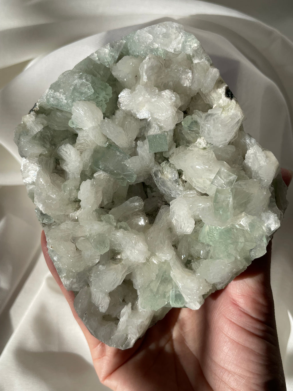 Beautiful crystal specimen featuring green apophyllite and stilbite, showcasing intricate formations and textures.