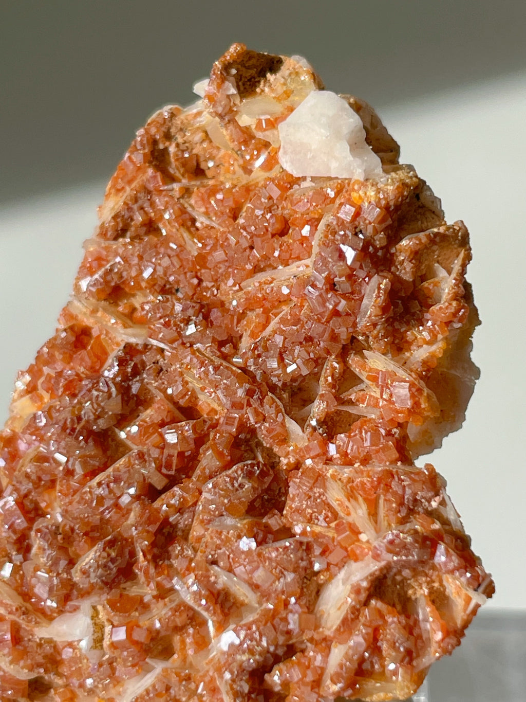 Moroccan vanadinite crystals shimmering on a barite matrix, showcasing vibrant reddish-brown hues and intricate textures.