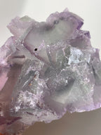 Beautiful crystal specimen of fluorite with shades of purple and green, showcasing natural formations.
