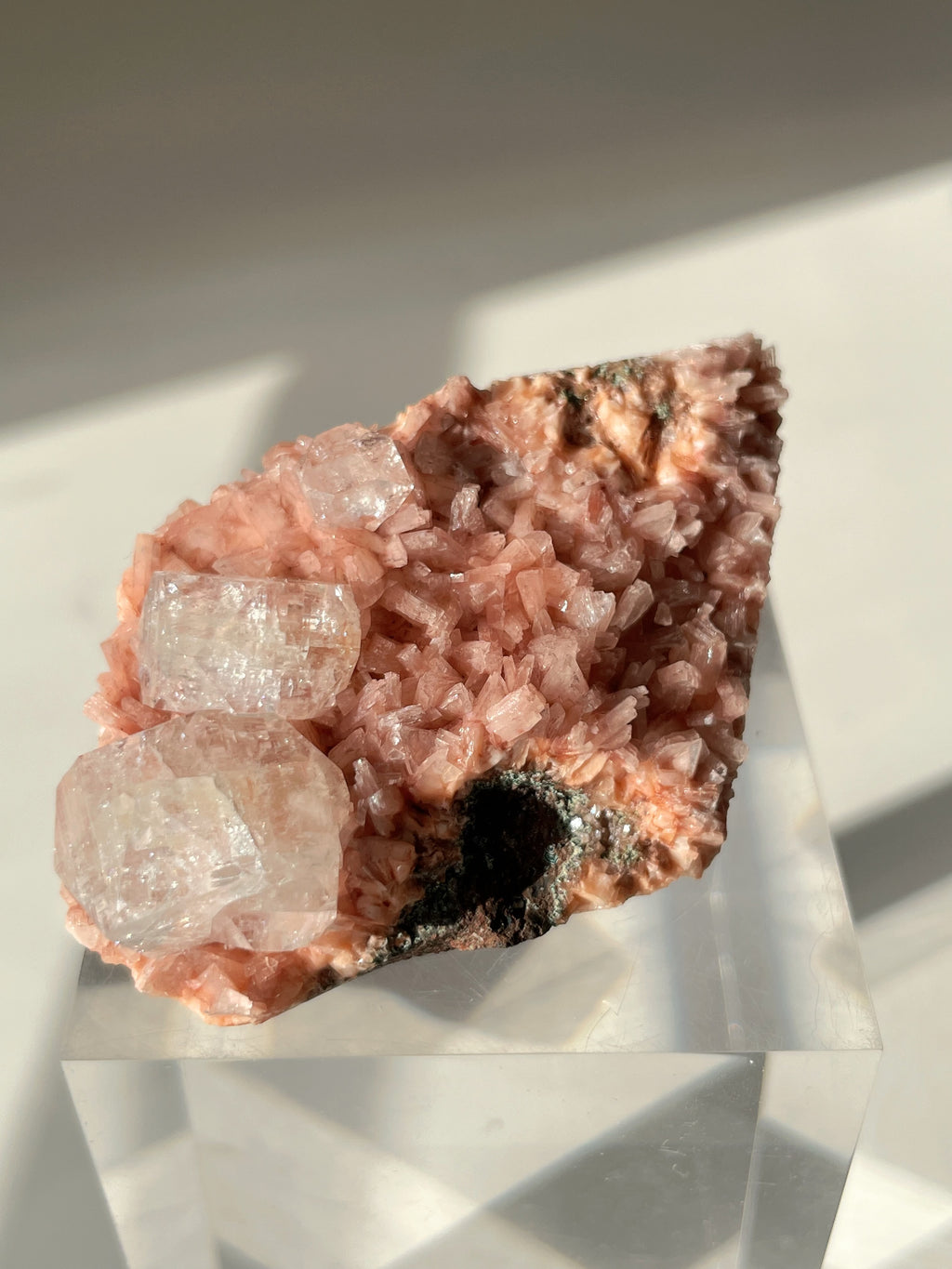 Beautiful pink Heulandite and Apophyllite crystal specimen on a clear display stand, showcasing its natural beauty.