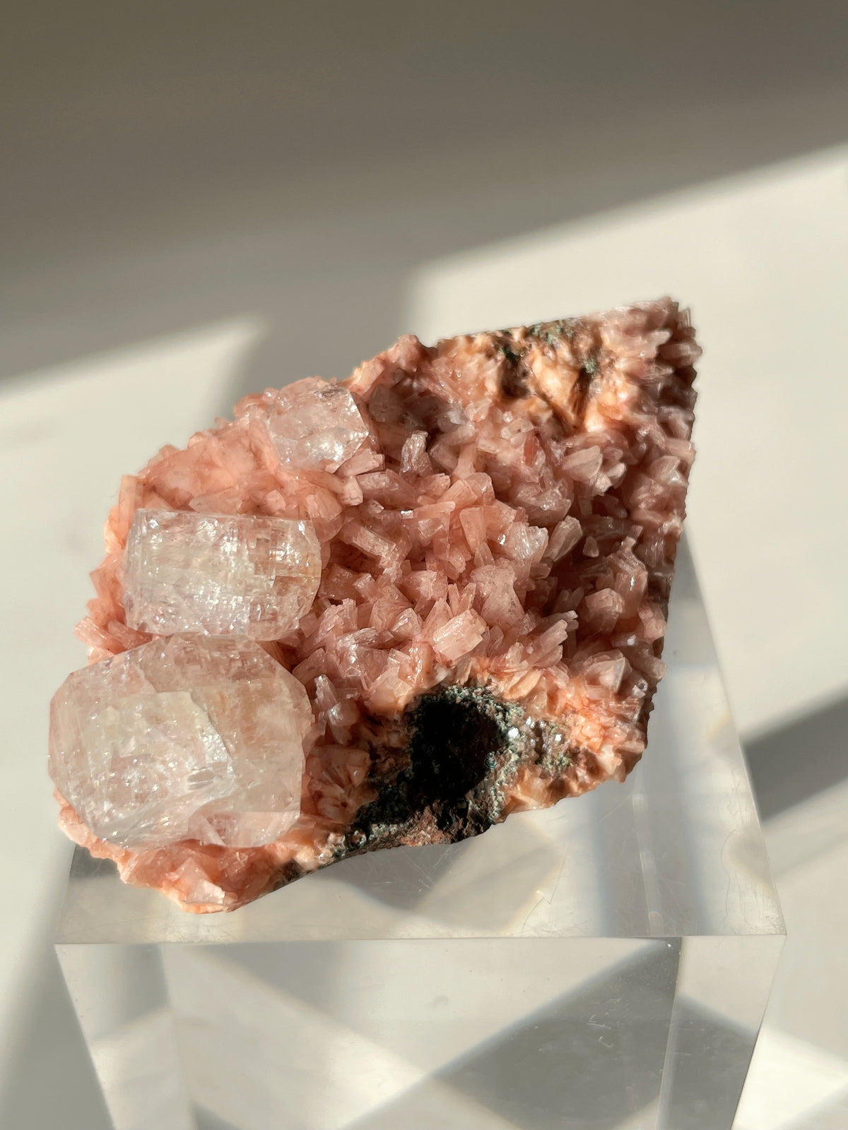 Beautiful pink Heulandite and Apophyllite crystal specimen on a clear display stand, showcasing its natural beauty.