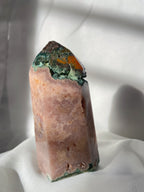 Pink amethyst tower with a natural crystal formation, showcasing beautiful hues and textures.