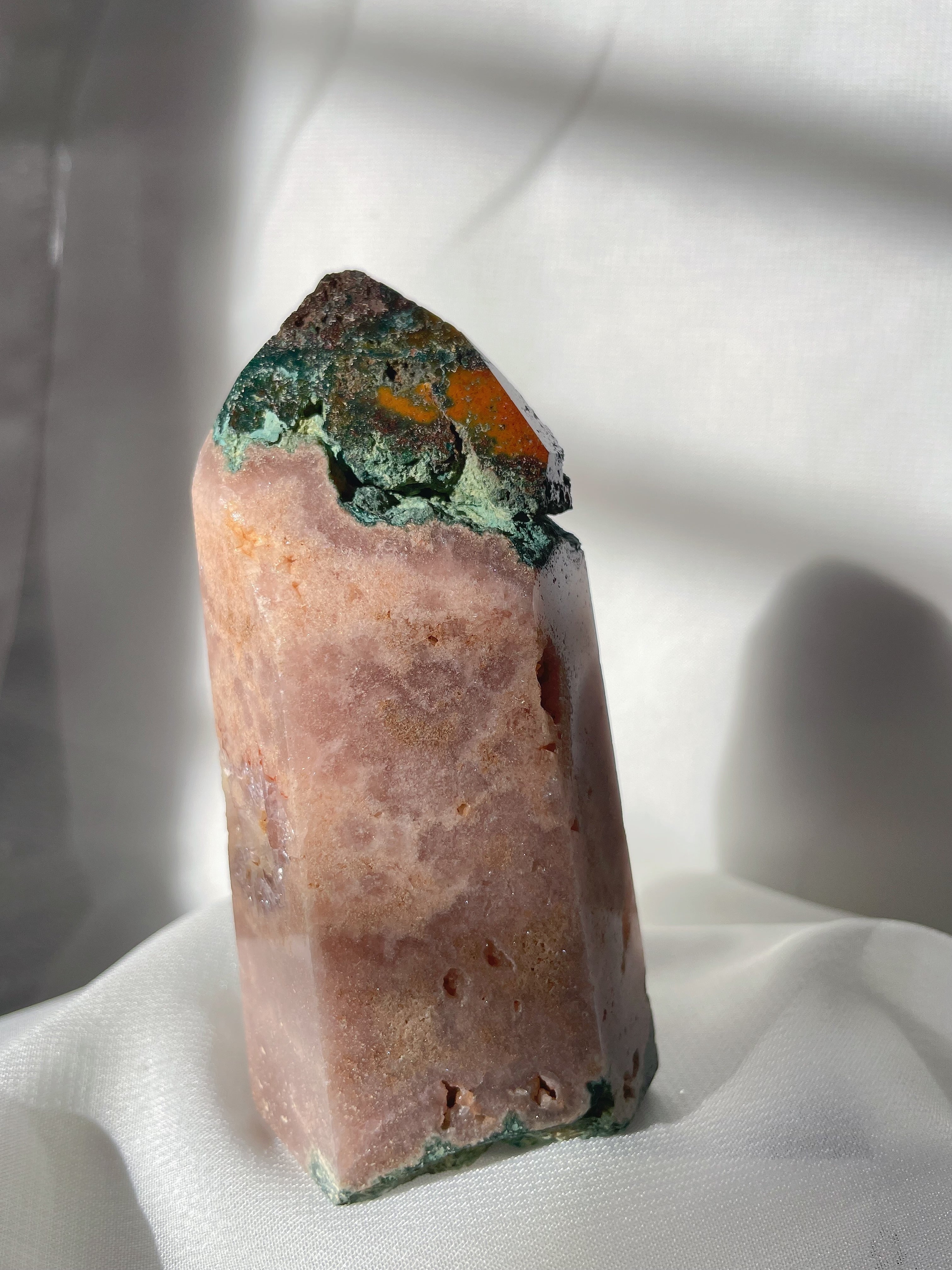 Pink amethyst tower with a natural crystal formation, showcasing beautiful hues and textures.