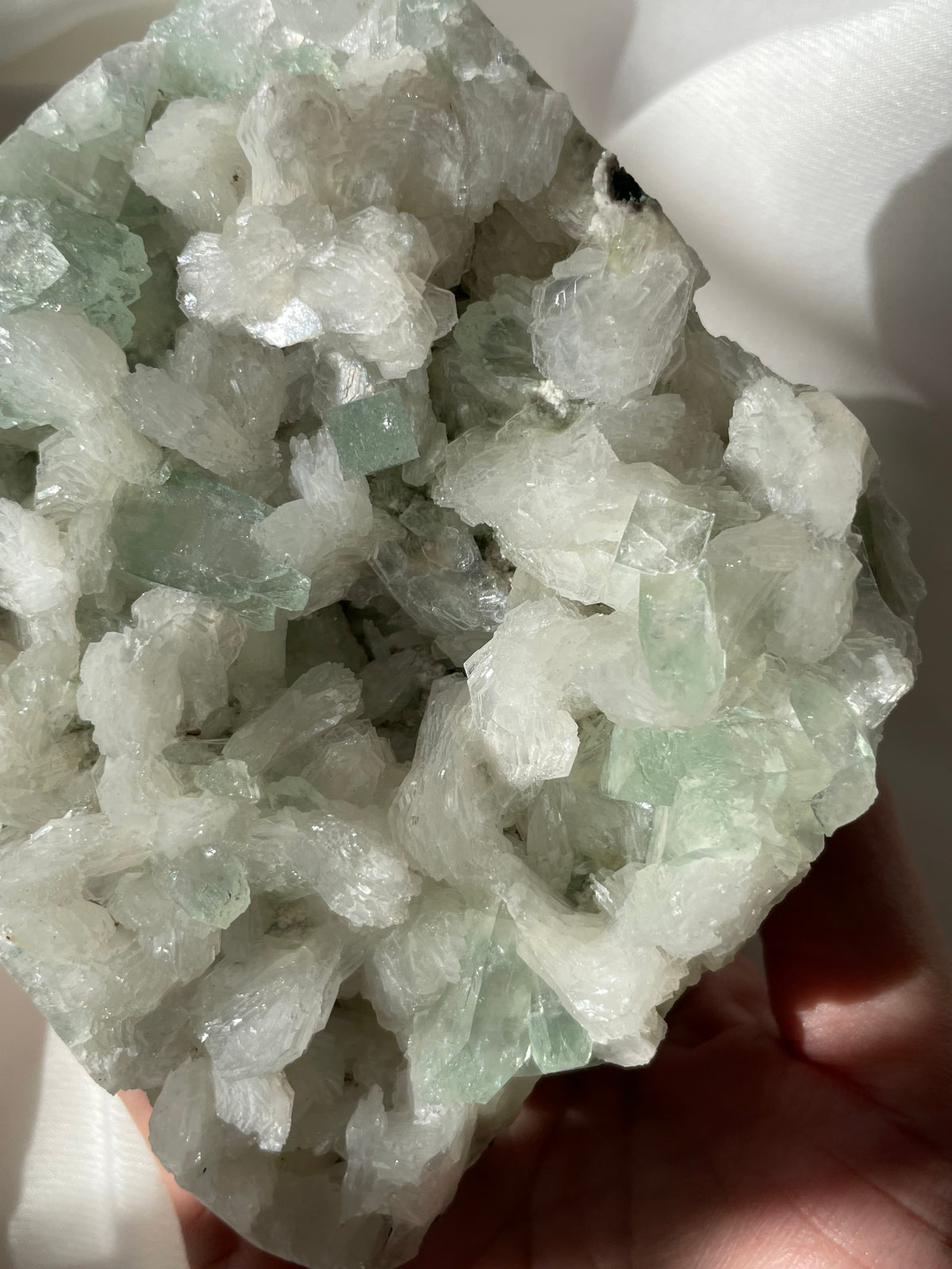 Beautiful crystal specimen featuring green apophyllite and stilbite, showcasing intricate formations and textures.