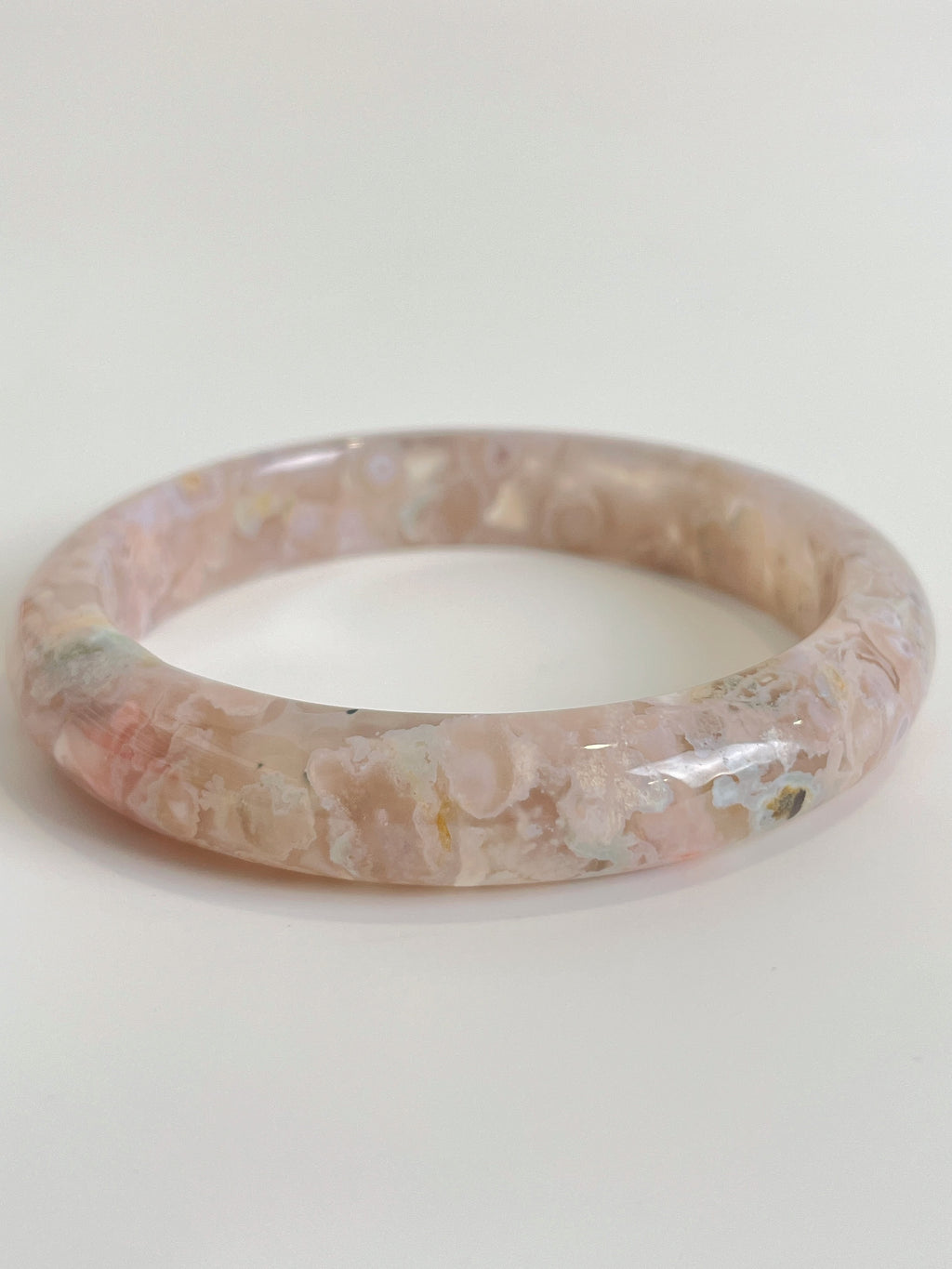 Beautiful flower agate bangle showcasing soft pink hues and natural patterns, perfect for stylish accessorizing.