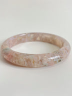 Beautiful flower agate bangle showcasing soft pink hues and natural patterns, perfect for stylish accessorizing.