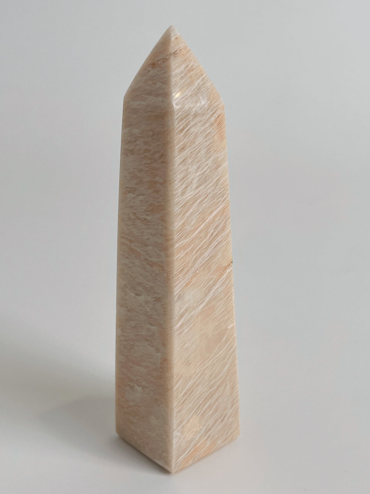 Peach Scolecite tower with a smooth, polished surface, showcasing its natural beauty and unique shape.