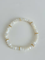 Elegant mother of pearl bracelet featuring smooth white beads and gold accents, perfect for any occasion.