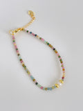 Colorful tourmaline and pearl bracelet featuring a mix of pastel beads and gold accents, perfect for layering.
