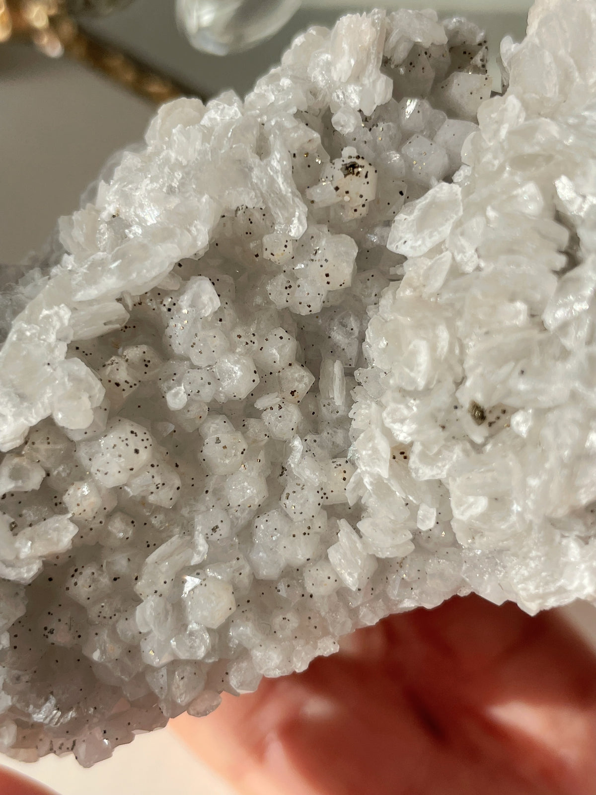 Close-up of a sparkling quartz specimen featuring clusters of pyrite and calcite, showcasing natural textures.