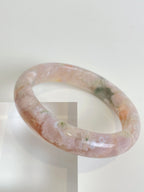 Beautiful flower agate bangle with soft pink hues and natural patterns, showcasing unique crystal details.