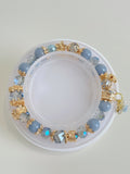 Beautiful angelite bracelet featuring 8.5mm beads, adorned with sparkling gold accents and crystal details.