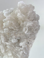 Biscuit Calcite specimen showcasing intricate crystal formations in soft, translucent hues.