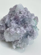 Beautiful crystal specimen of sugar fluorite featuring a mix of purple and green hues, showcasing its natural texture.