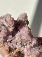 Beautiful purple creedite crystal specimen with sparkling facets and a natural texture, showcasing its unique color.