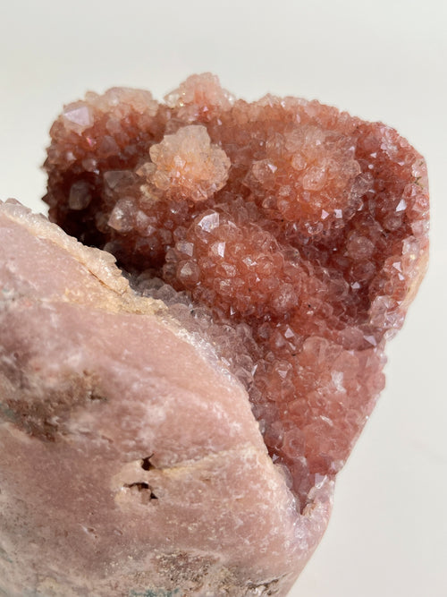 Beautiful botryoidal pink amethyst freeform crystal specimen with sparkling facets and soft pink hues.