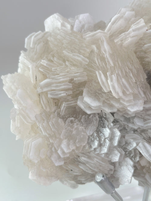 Beautiful crystal specimen featuring intricate layers and textures in a light, translucent hue.