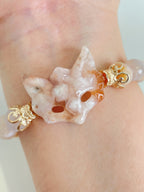 Beautiful flower agate fox bracelet with gold accents, showcasing intricate detailing and a soft pink hue.
