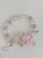 Beautiful bracelet featuring pink amethyst and sparkling crystal accents, adorned with delicate butterfly charms.